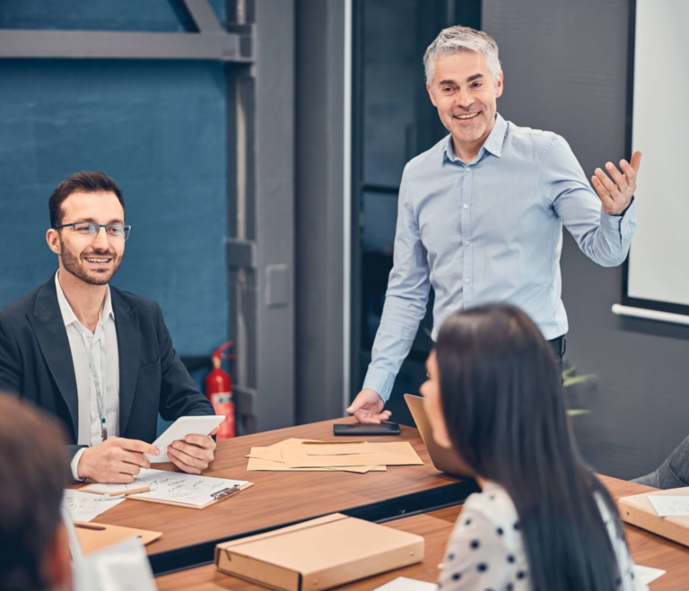 meeting room with man presenting to a group of people