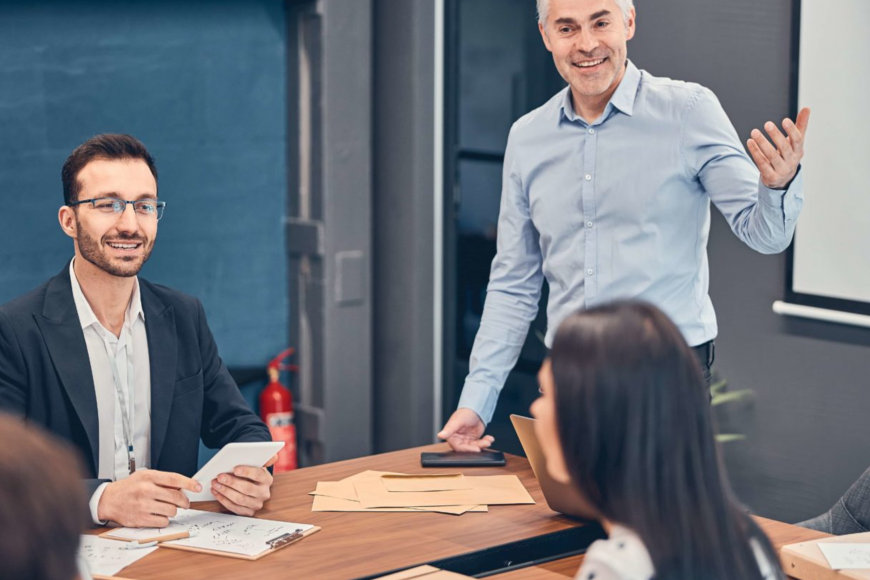 meeting room with man presenting to a group of people